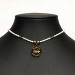 Aquarius Reef's 'Aquarius' choker - a white pearl and gold unisex beaded choker necklace from Aquarius Reef's Pearl collection, featuring a pendant with coordinates of the Great Barrier Reef.