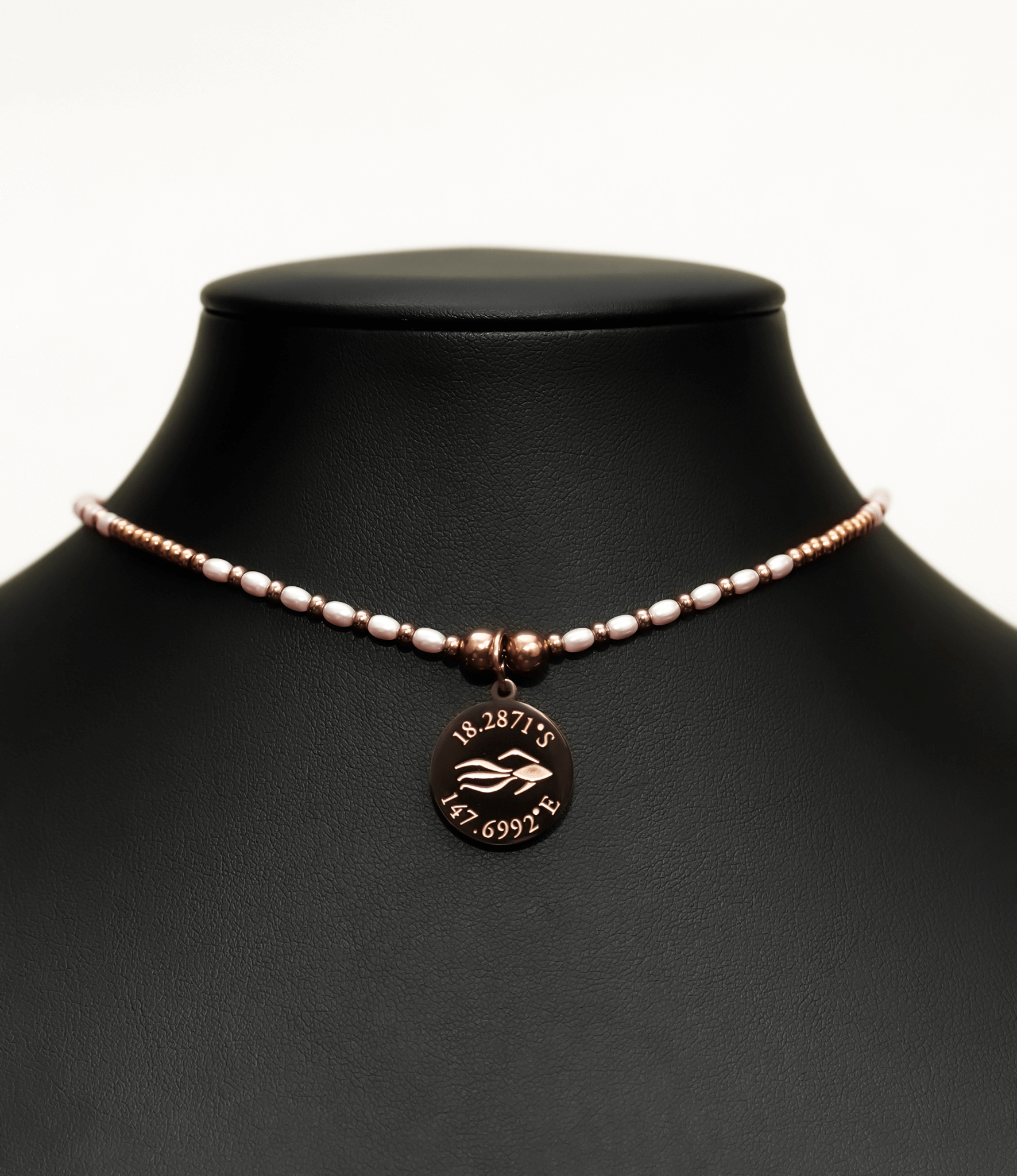 Aquarius Reef's pink pearl 'Aphrodite' choker - a pink pearl and rose gold unisex beaded choker necklace from Aquarius Reef's Pearl collection, featuring a pendant with coordinates of the Great Barrier Reef.