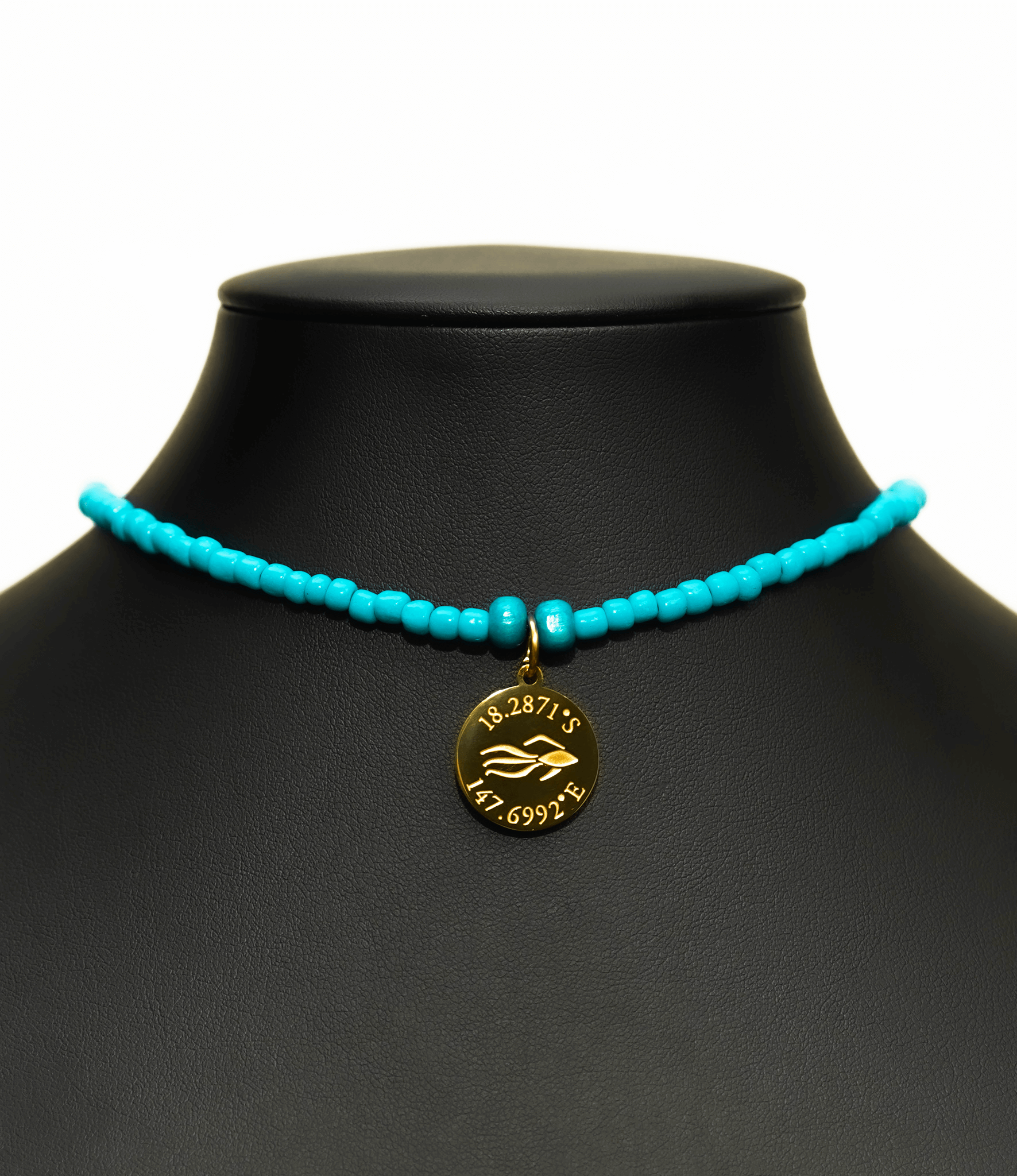 Aquarius Reef's gold 'Caribbean' choker - an all turquoise unisex seed beaded choker necklace in gold from Aquarius Reef's Edge collection, featuring a pendant with coordinates of the Great Barrier Reef. 