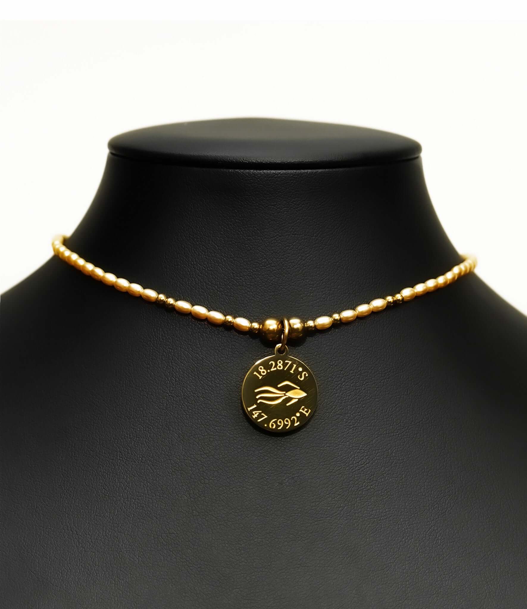 Aquarius Reef's 'Cleopatra' choker - a yellow pearl and gold unisex beaded choker necklace from Aquarius Reef's Pearl collection, featuring a pendant with coordinates of the Great Barrier Reef.