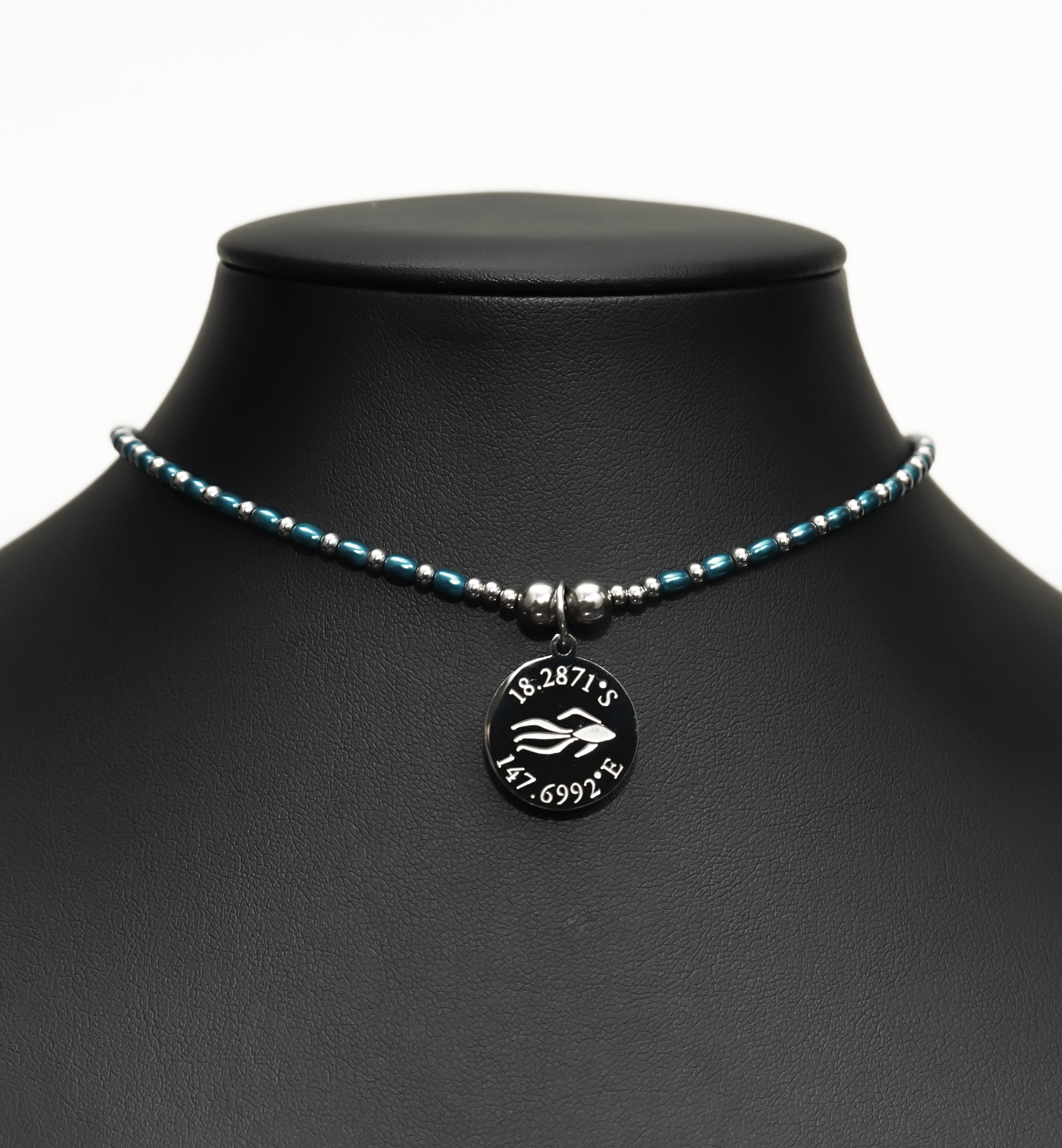 Aquarius Reef's 'Cobra' choker - a blue pearl and silver unisex beaded choker necklace from Aquarius Reef's Pearl collection, featuring a pendant with coordinates of the Great Barrier Reef.
