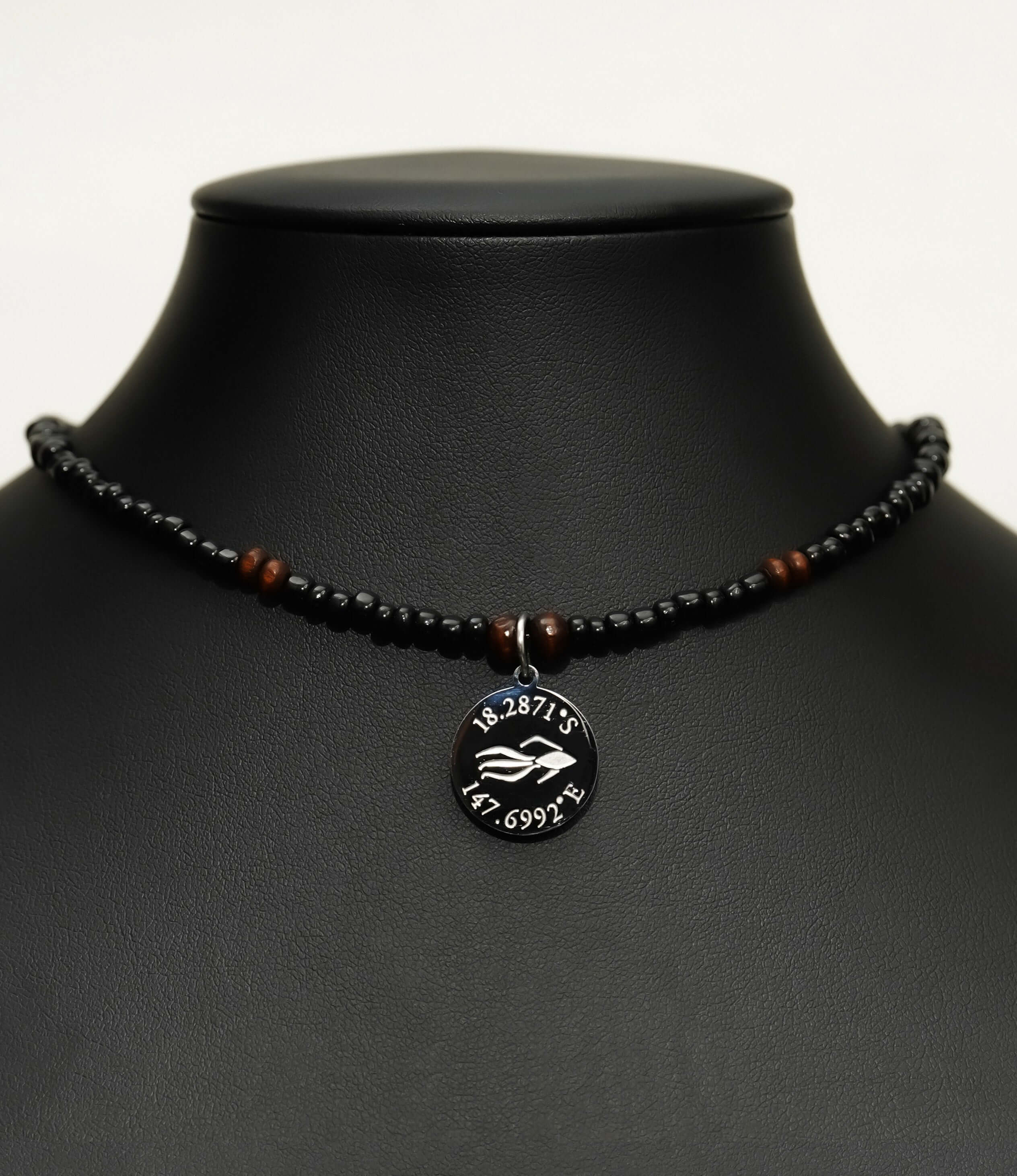 Aquarius Reef's silver 'Dare' choker - a black and silver unisex beaded choker necklace from Aquarius Reef's Classic collection, featuring a pendant with coordinates of the Great Barrier Reef.
