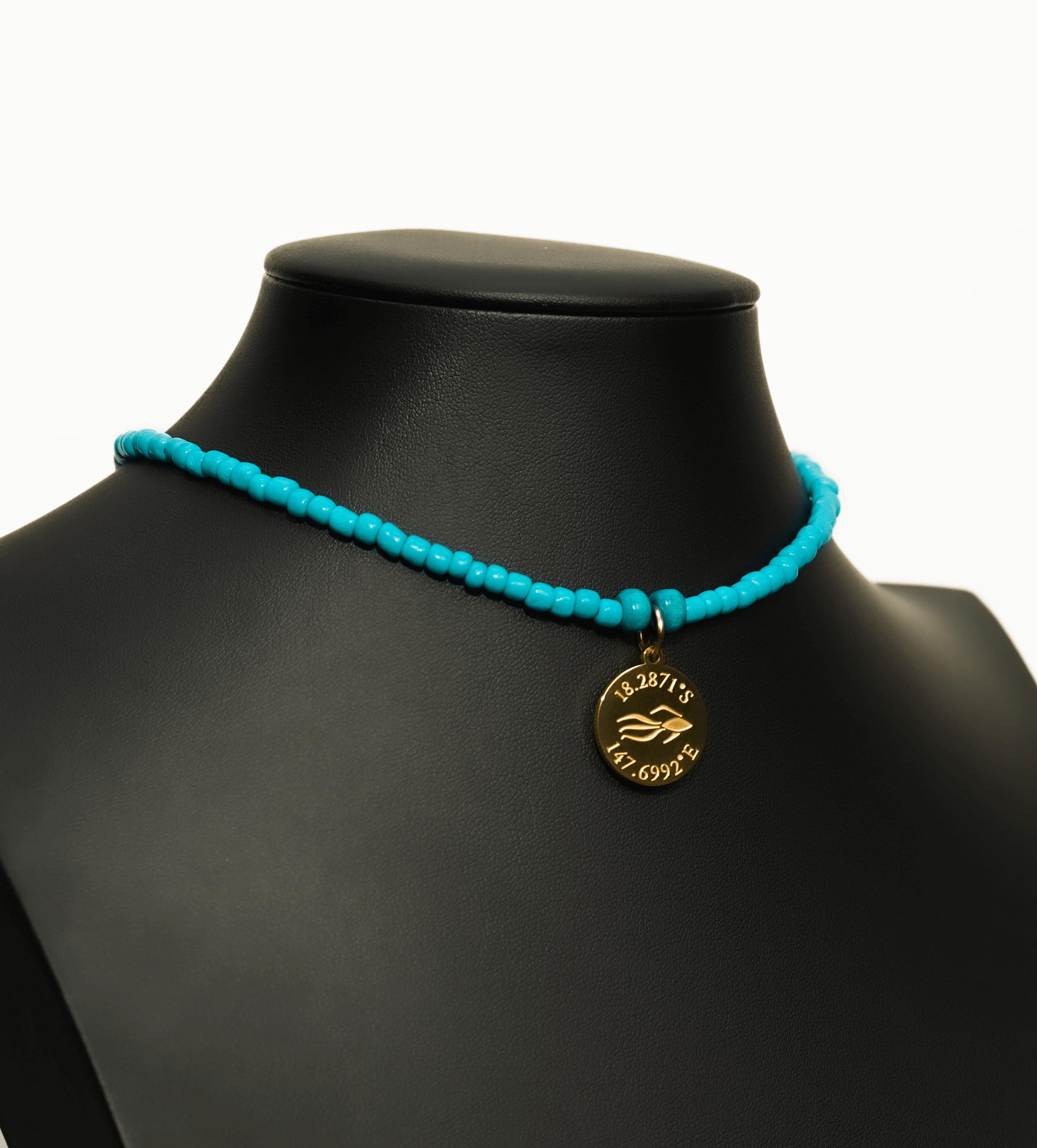Aquarius Reef's gold 'Caribbean' choker - an all turquoise unisex seed beaded choker necklace in gold from Aquarius Reef's Edge collection, featuring a pendant with coordinates of the Great Barrier Reef. 