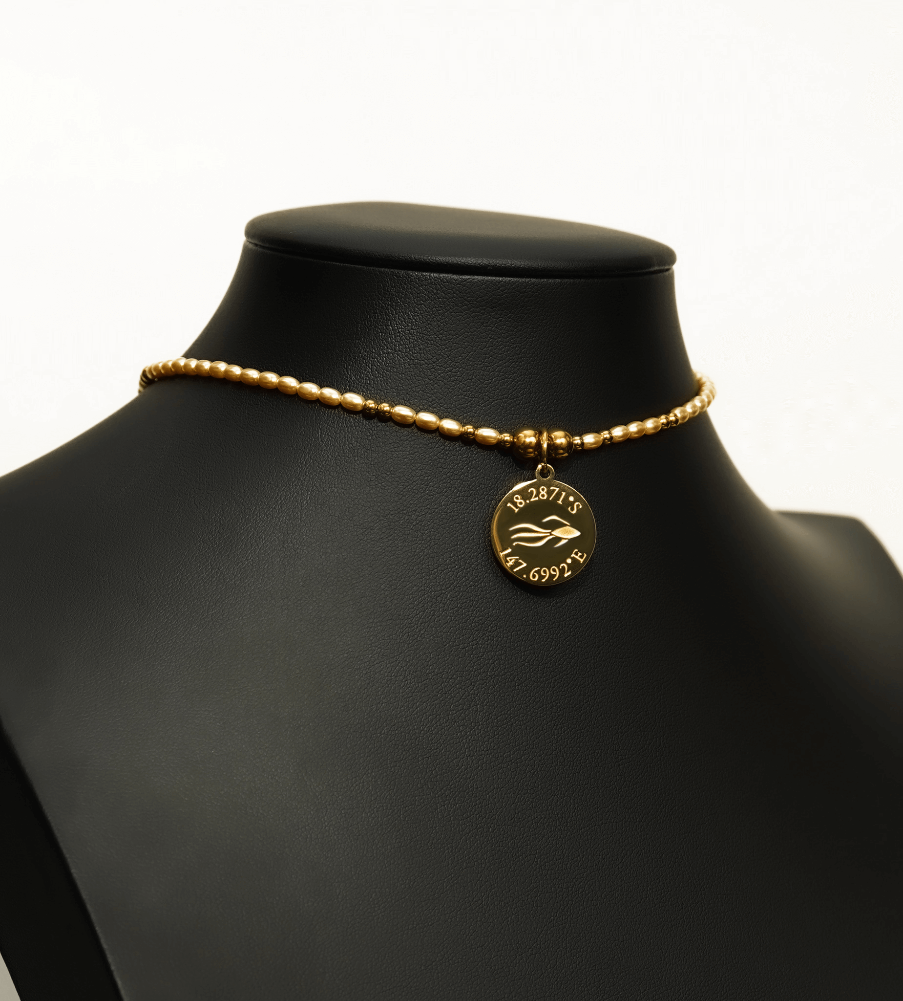 Aquarius Reef's 'Cleopatra' choker - a yellow pearl and gold unisex beaded choker necklace from Aquarius Reef's Pearl collection, featuring a pendant with coordinates of the Great Barrier Reef.