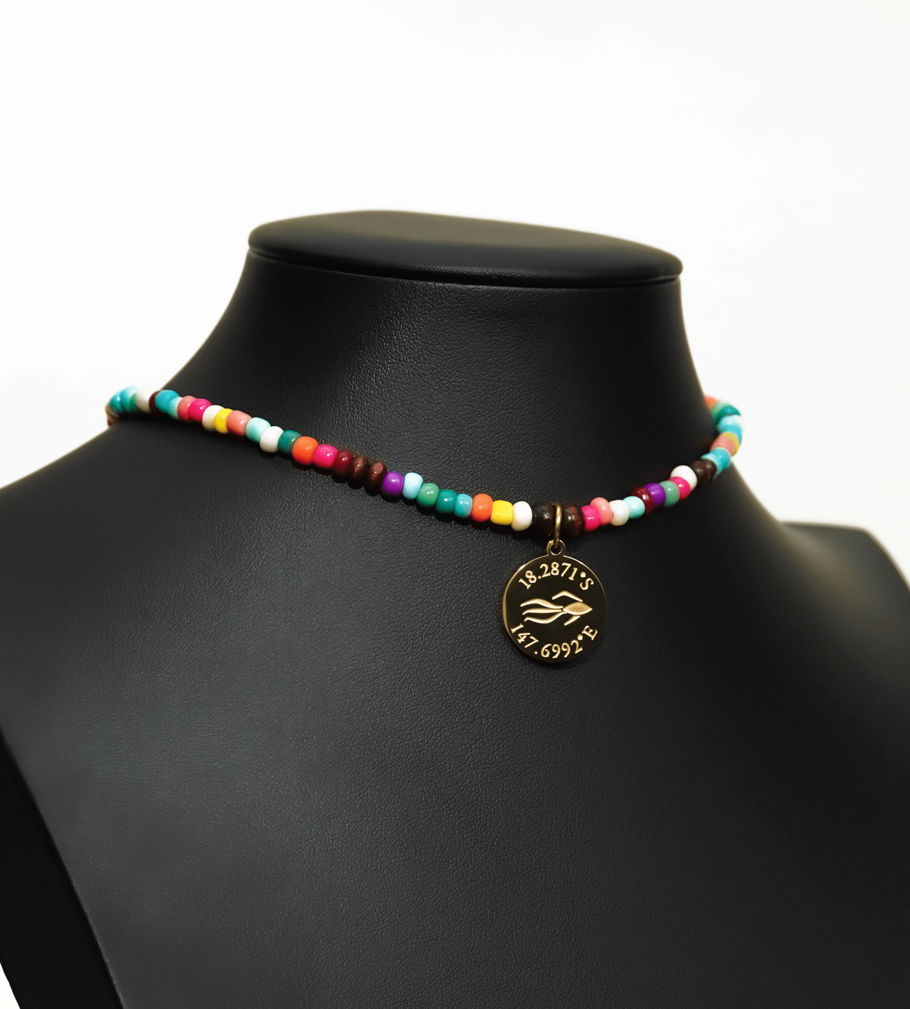 Aquarius Reef's gold 'Free' choker - a rainbow multicolor unisex seed beaded choker necklace in gold from Aquarius Reef's Edge collection, featuring a pendant with coordinates of the Great Barrier Reef. 
