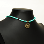 Aquarius Reef's gold 'Mermaid' choker - a seafoam colored unisex seed beaded choker necklace in gold from Aquarius Reef's Edge collection, featuring a pendant with coordinates of the Great Barrier Reef.