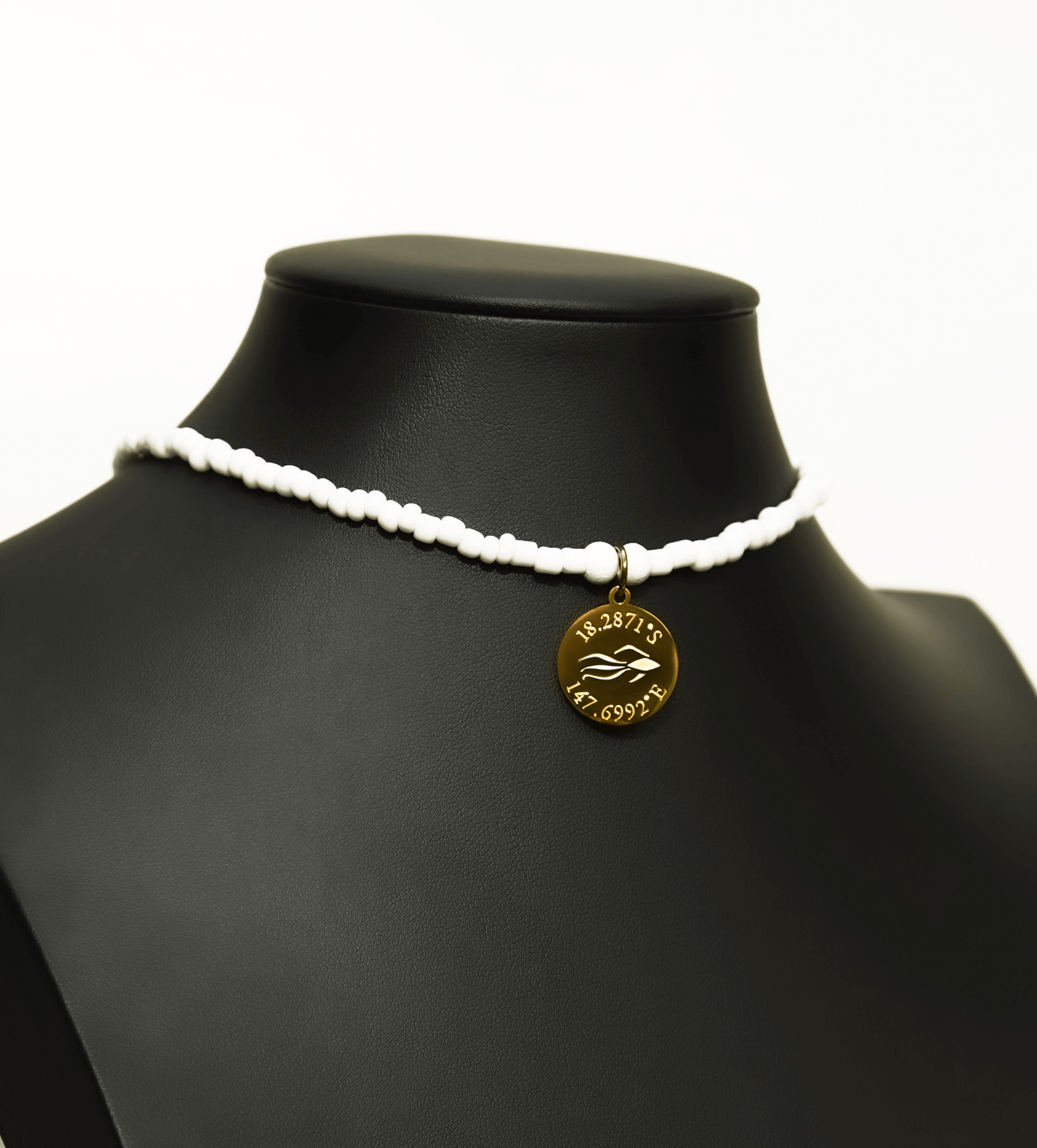 Aquarius Reef's gold 'Nautical' choker - an all white unisex seed beaded choker necklace in gold from Aquarius Reef's Edge collection, featuring a pendant with coordinates of the Great Barrier Reef. 