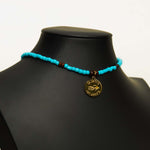 Aquarius Reef's gold 'Reef' choker - a turquoise and gold unisex beaded choker necklace from Aquarius Reef's Classic collection, featuring a pendant with coordinates of the Great Barrier Reef.