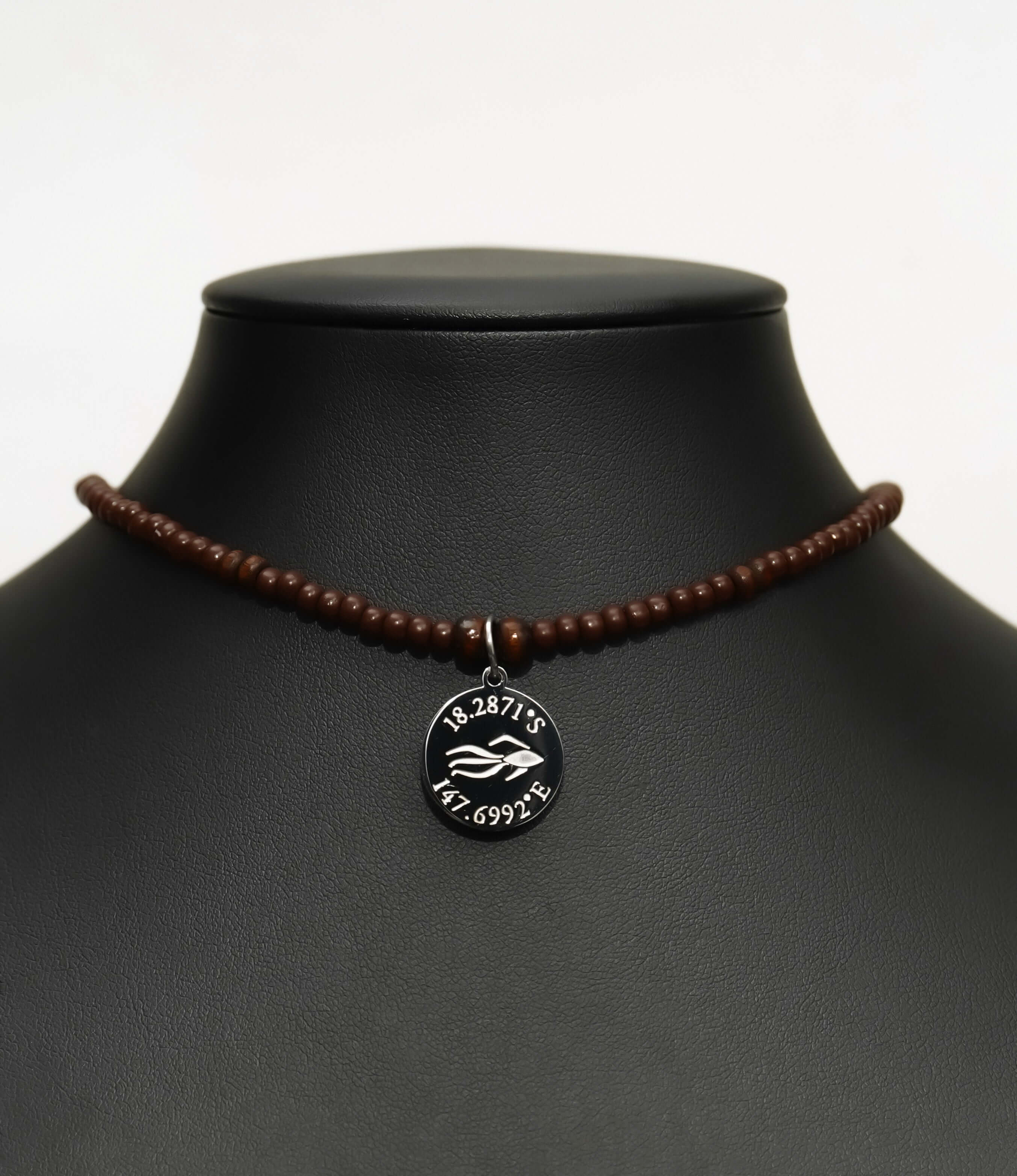 Aquarius Reef's silver 'Intimate' choker - a brown unisex beaded choker necklace in silver from Aquarius Reef's Classic collection, featuring a pendant with coordinates of the Great Barrier Reef.