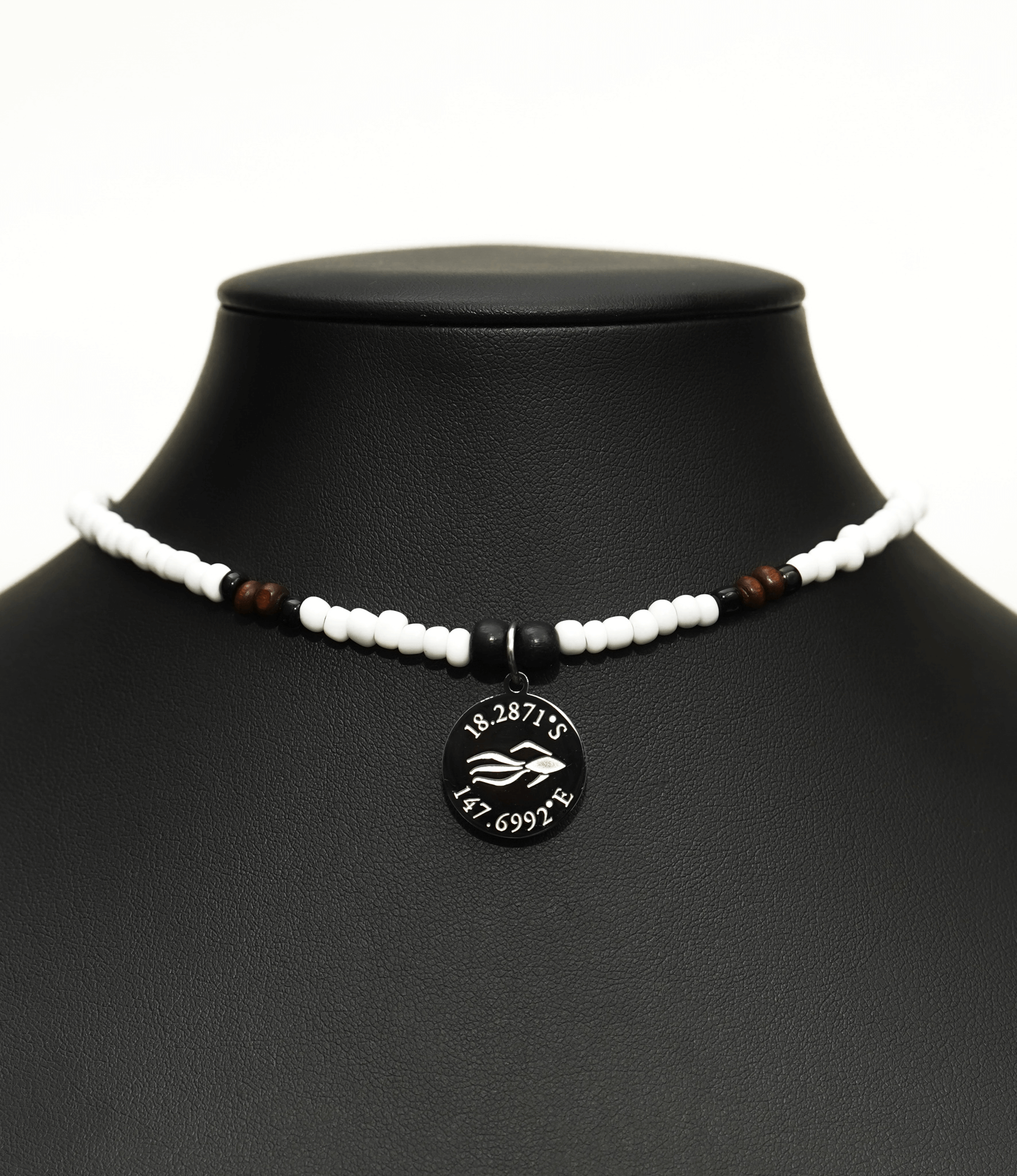 Aquarius Reef's 'Loyal' choker - a white and black patterned unisex seed beaded choker necklace in silver from Aquarius Reef's Edge collection, featuring a pendant with coordinates of the Great Barrier Reef.
