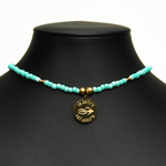 Aquarius Reef's gold 'Mermaid' choker - a seafoam colored unisex seed beaded choker necklace in gold from Aquarius Reef's Edge collection, featuring a pendant with coordinates of the Great Barrier Reef.