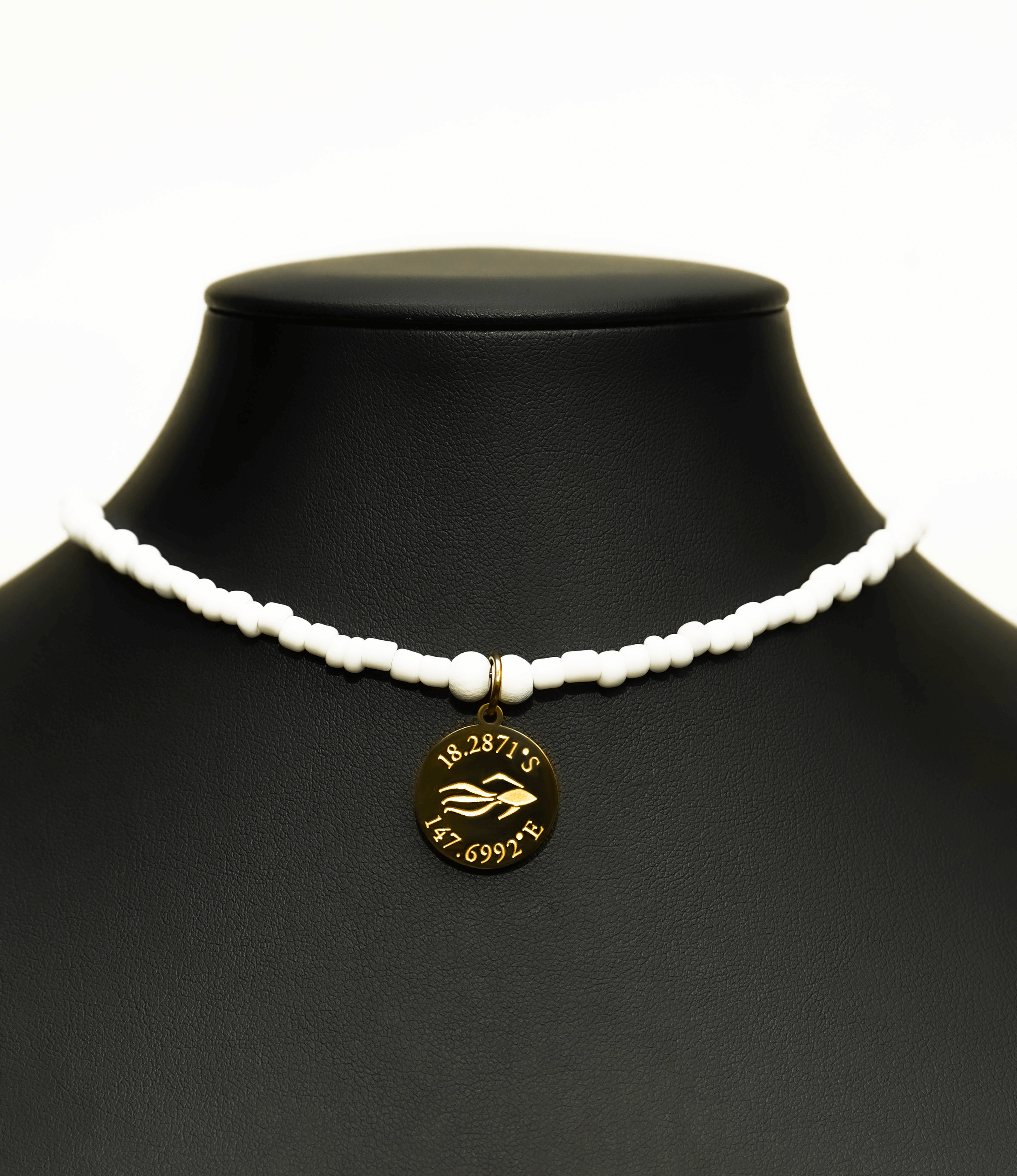 Aquarius Reef's gold 'Nautical' choker - an all white unisex seed beaded choker necklace in gold from Aquarius Reef's Edge collection, featuring a pendant with coordinates of the Great Barrier Reef. 