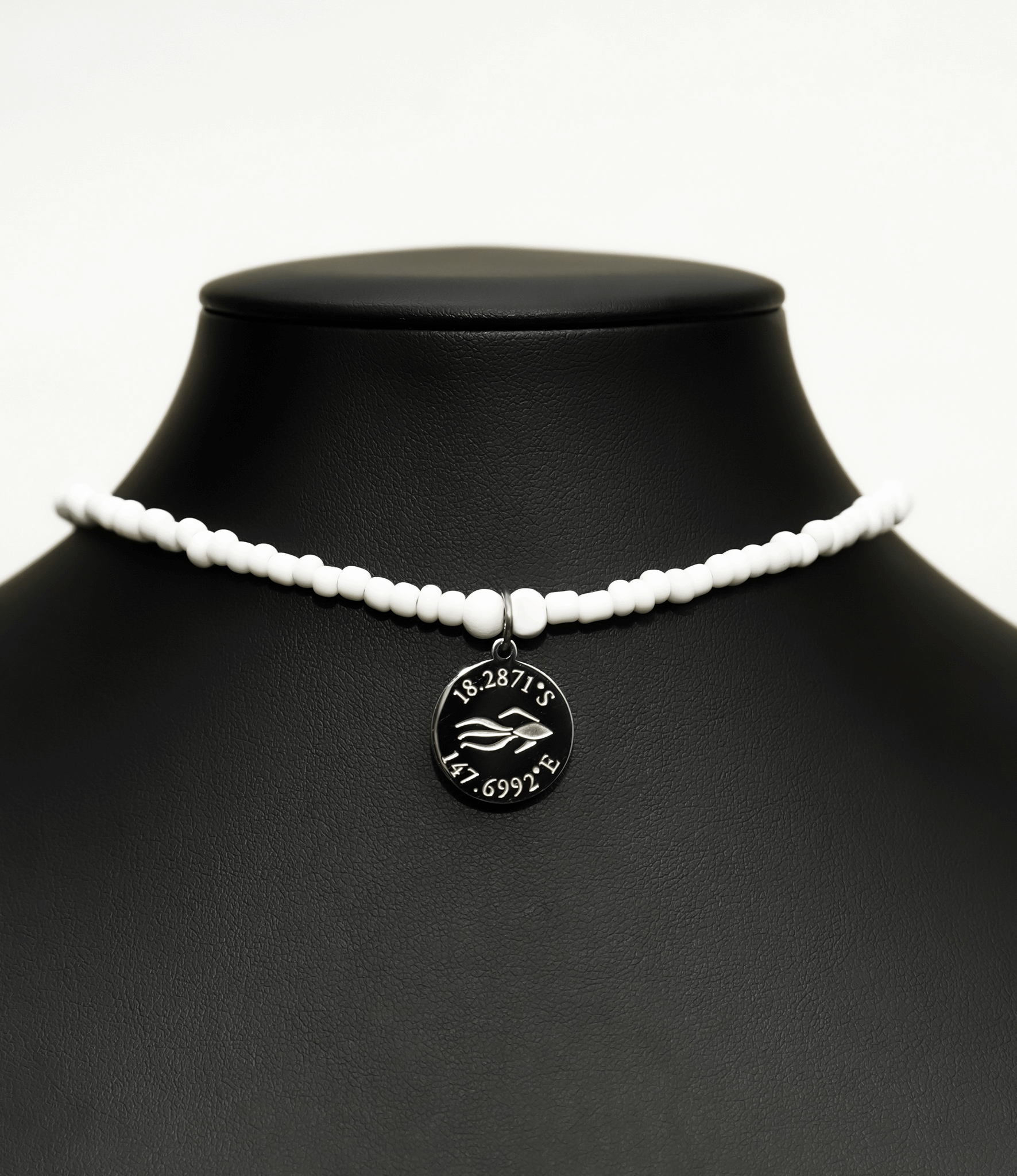 Aquarius Reef's silver 'Nautical' choker - an all white unisex seed beaded choker necklace in silver from Aquarius Reef's Edge collection, featuring a pendant with coordinates of the Great Barrier Reef.