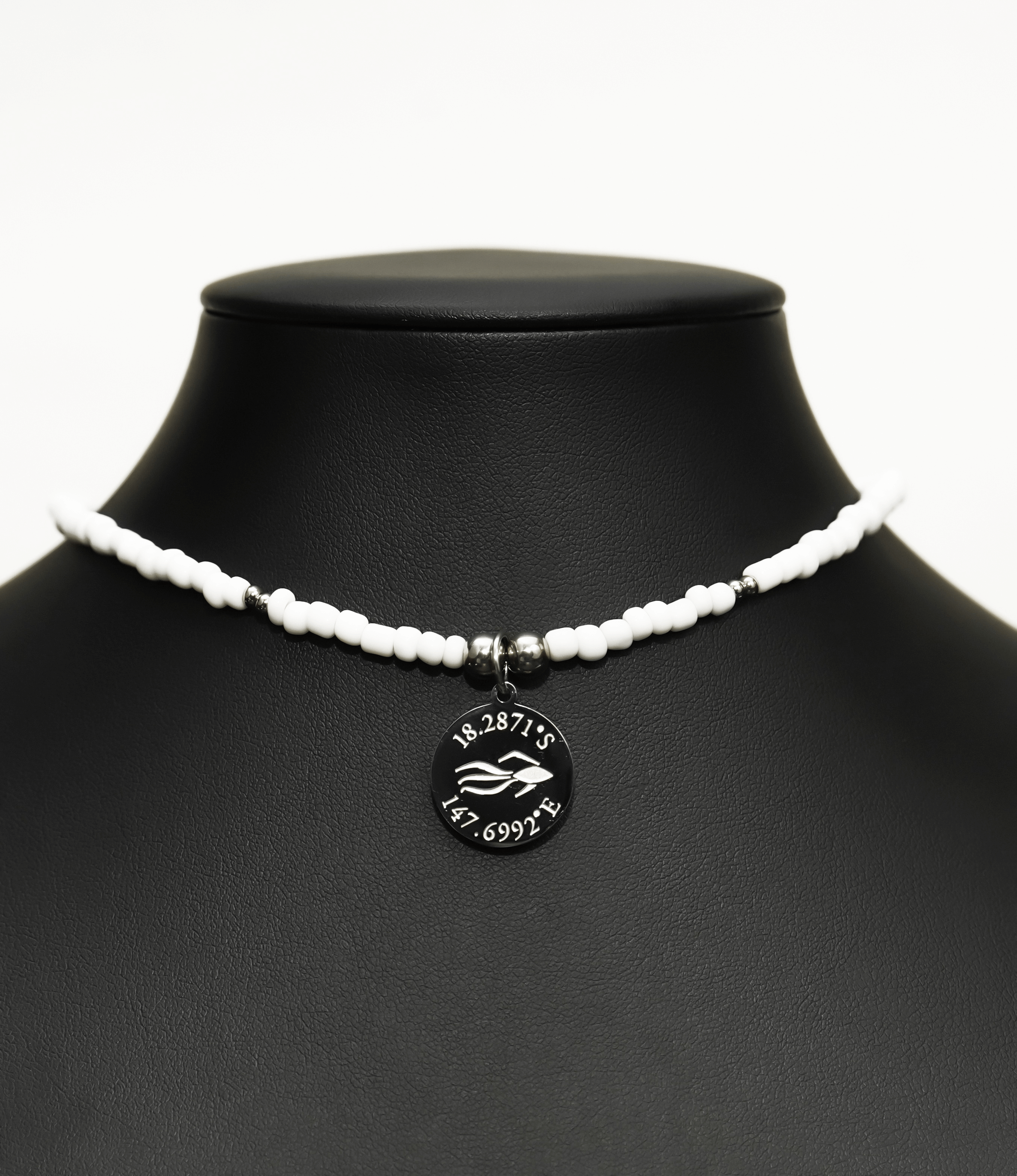 Aquarius Reef's silver 'Posh' choker - a white and silver unisex seed beaded choker necklace from Aquarius Reef's Edge collection, featuring a pendant with coordinates of the Great Barrier Reef.
