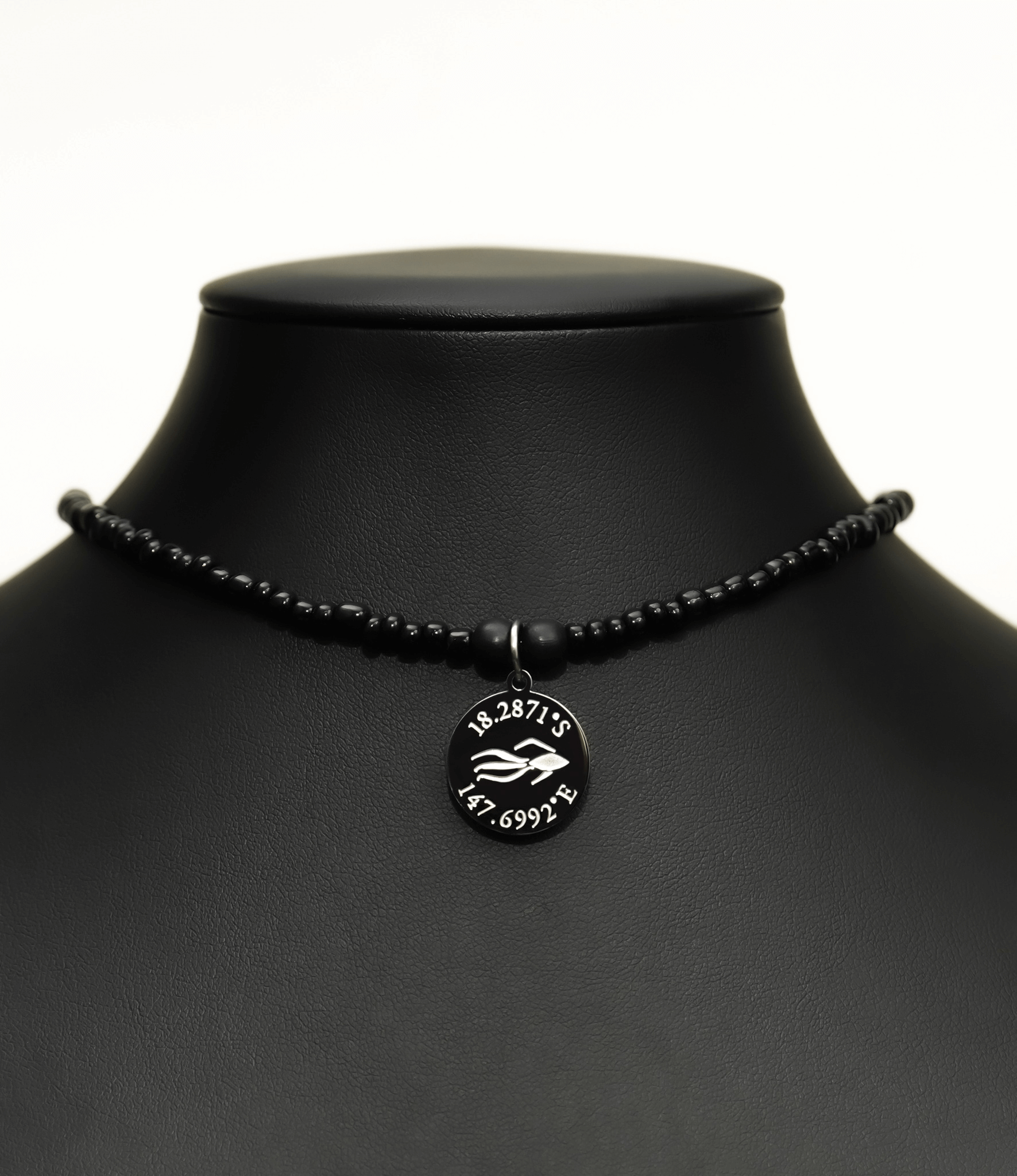 Aquarius Reef's silver 'Revenge' choker - an all black unisex seed beaded choker necklace in silver from Aquarius Reef's Edge collection, featuring a pendant with coordinates of the Great Barrier Reef.