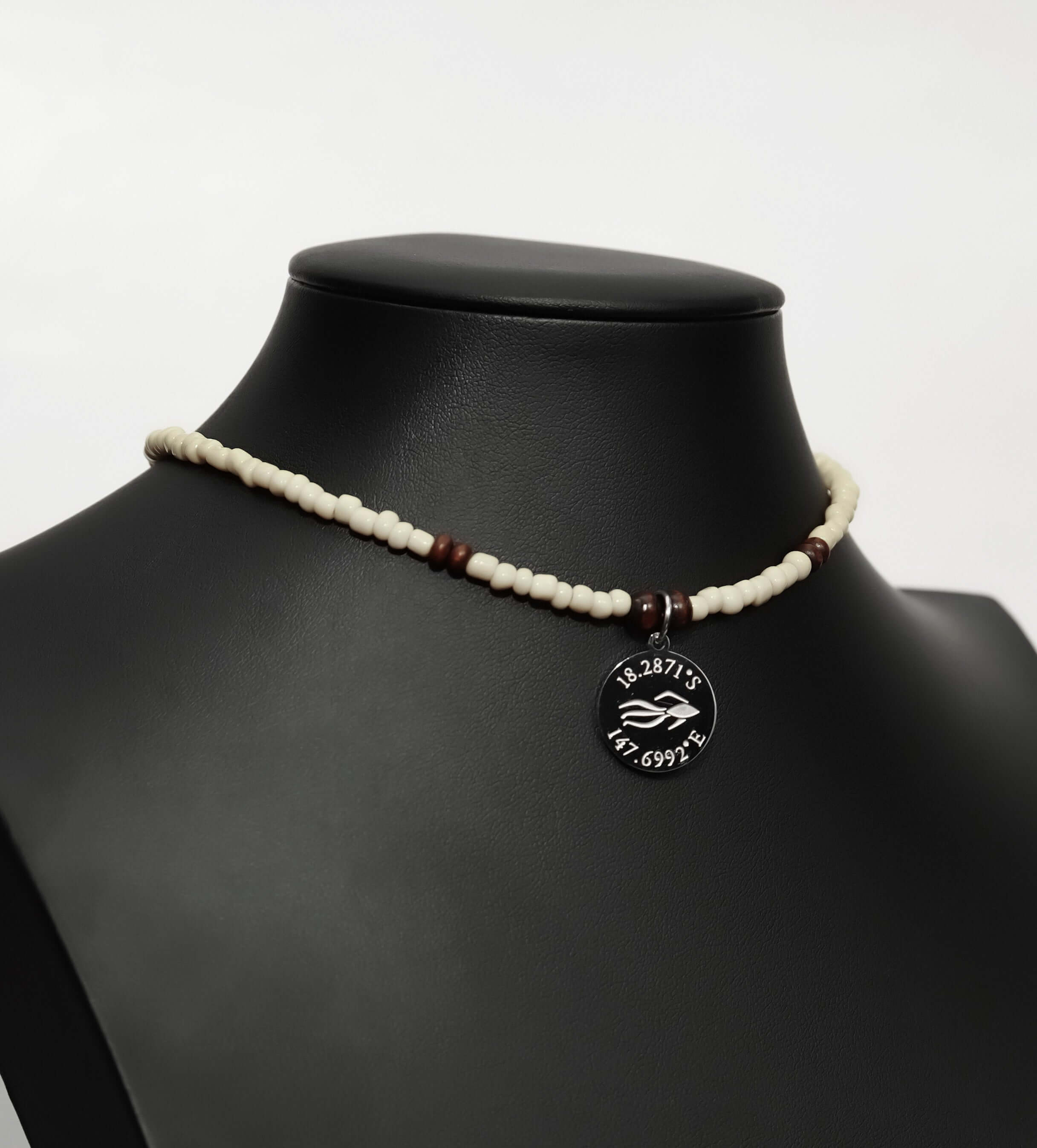 Aquarius Reef's 'Australian' choker - a cream-colored unisex beaded choker necklace in silver from Aquarius Reef's Classic collection, featuring a pendant with coordinates of the Great Barrier Reef.