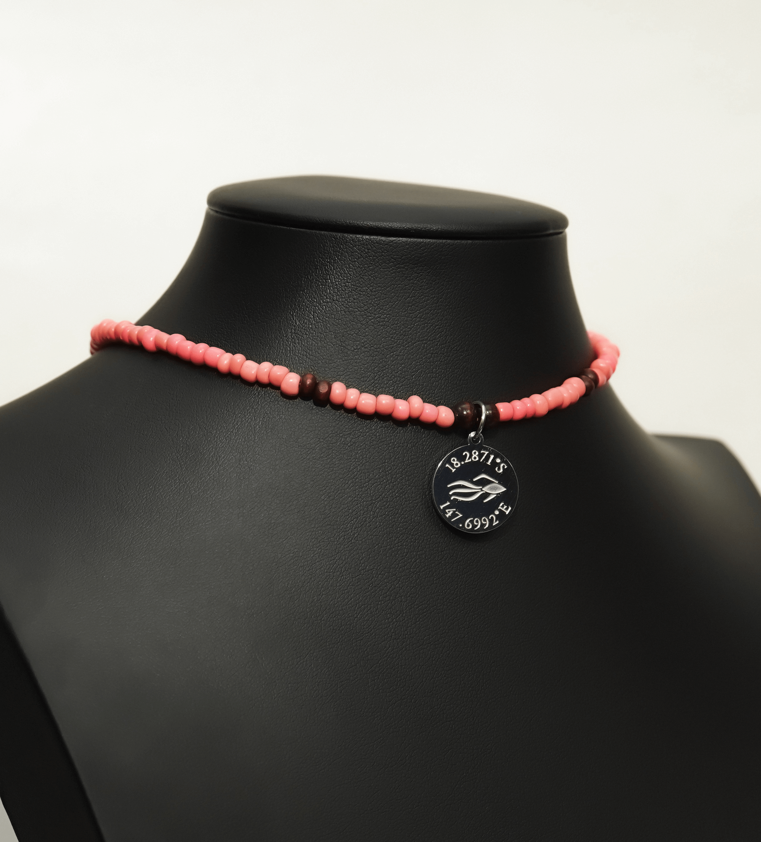 Aquarius Reef's 'Betta' choker - a coral pink unisex beaded choker necklace in silver from Aquarius Reef's Classic collection, featuring a pendant with coordinates of the Great Barrier Reef.