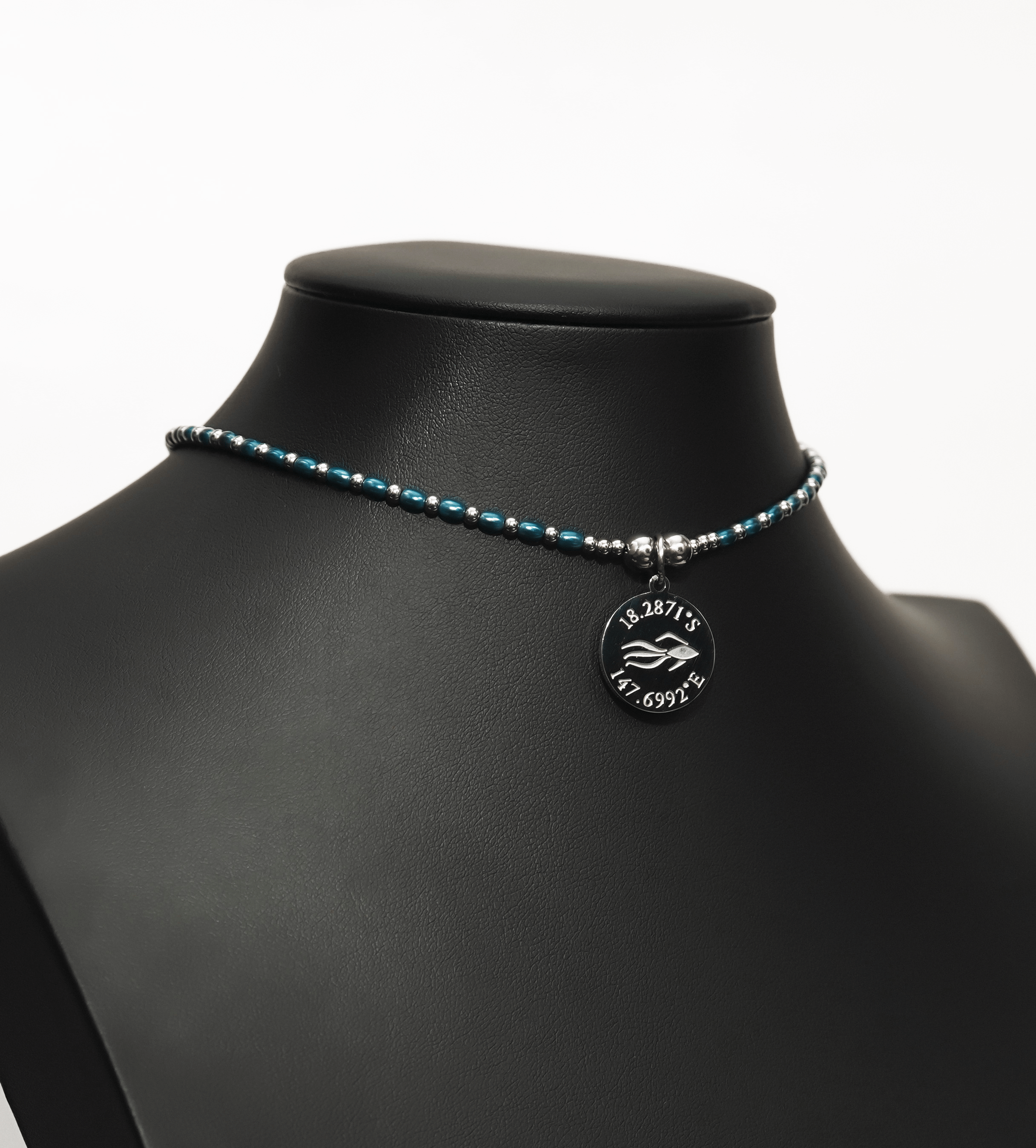 Aquarius Reef's 'Cobra' choker - a blue pearl and silver unisex beaded choker necklace from Aquarius Reef's Pearl collection, featuring a pendant with coordinates of the Great Barrier Reef.