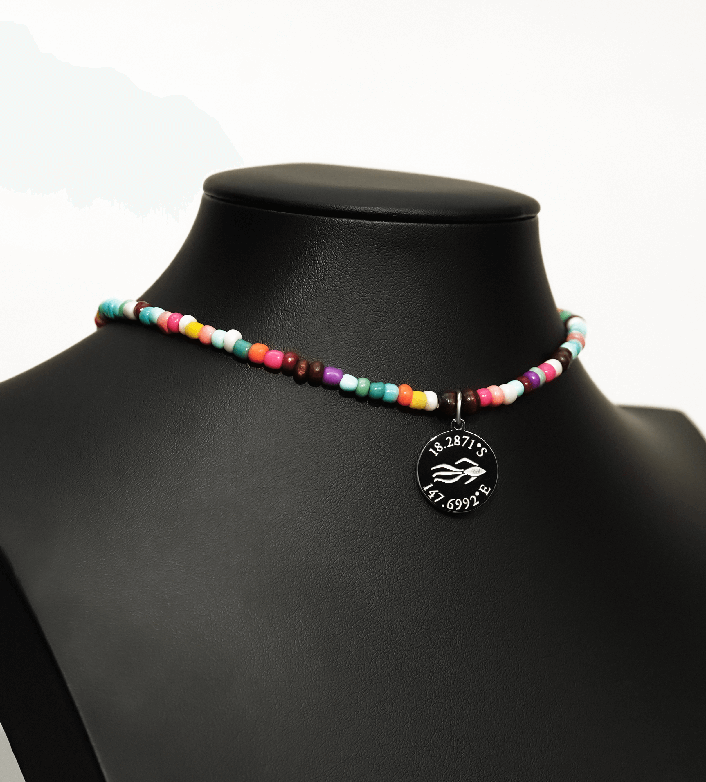 Aquarius Reef's silver 'Free' choker - a rainbow multicolor unisex seed beaded choker necklace in silver from Aquarius Reef's Edge collection, featuring a pendant with coordinates of the Great Barrier Reef.