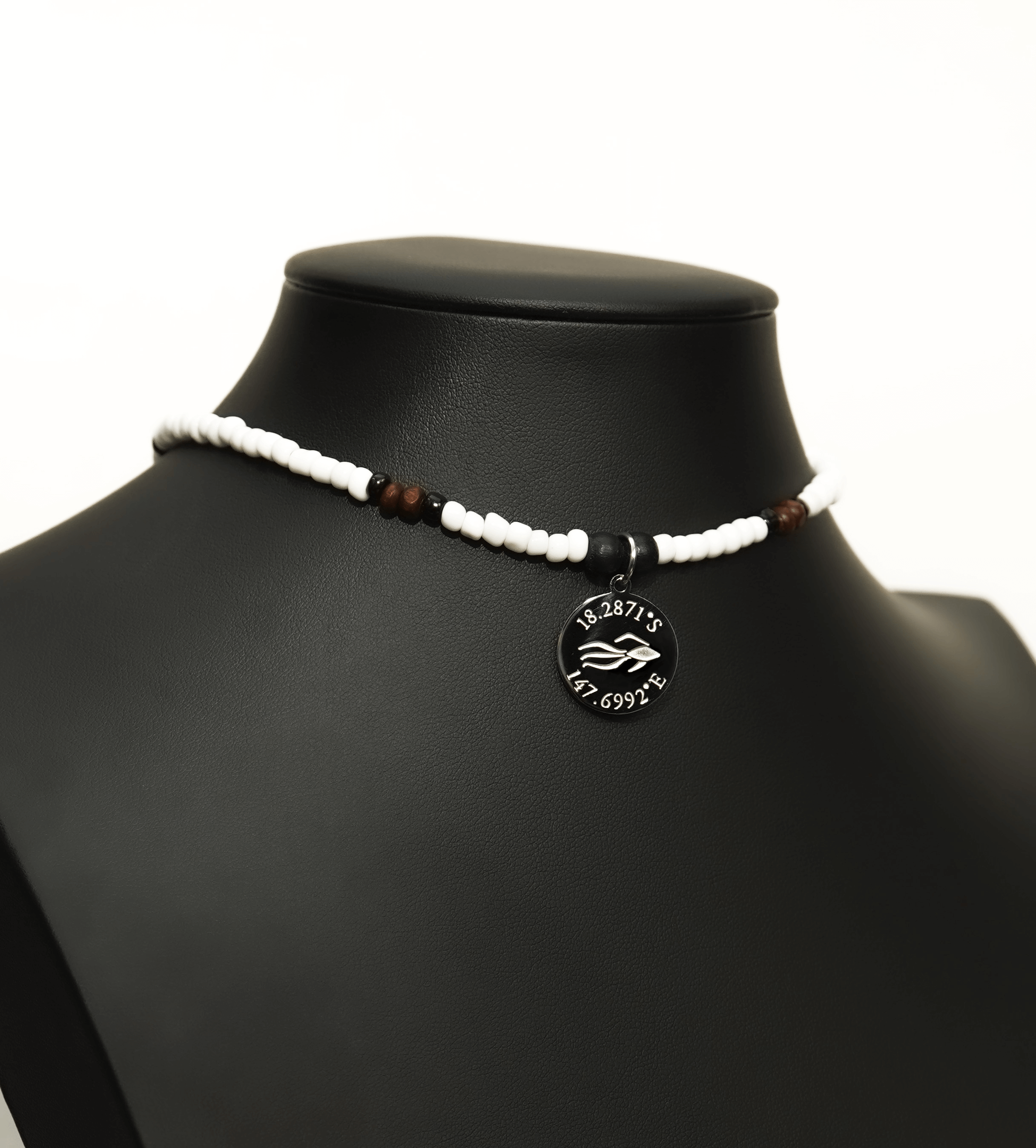 Aquarius Reef's 'Loyal' choker - a white and black patterned unisex seed beaded choker necklace in silver from Aquarius Reef's Edge collection, featuring a pendant with coordinates of the Great Barrier Reef.