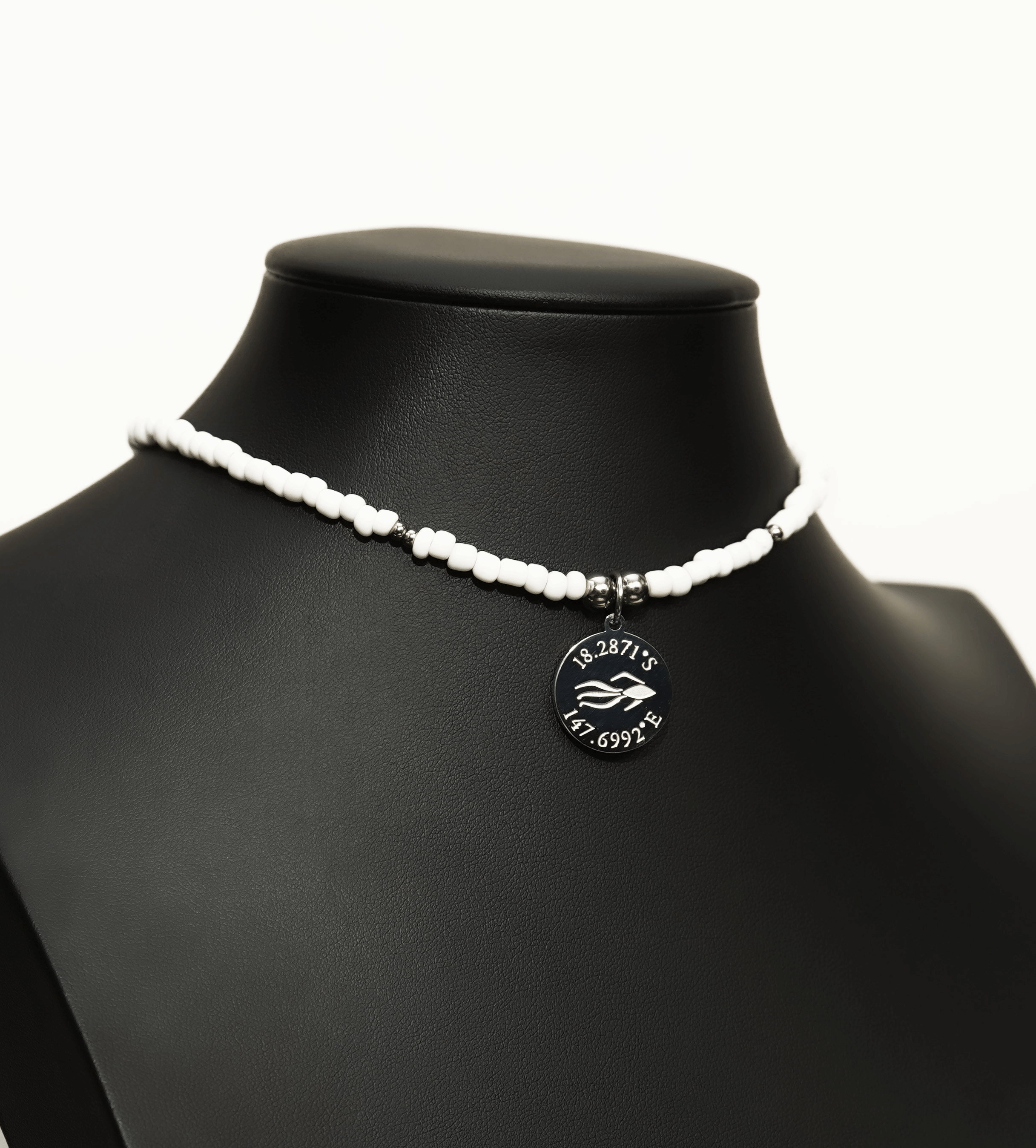 Aquarius Reef's silver 'Posh' choker - a white and silver unisex seed beaded choker necklace from Aquarius Reef's Edge collection, featuring a pendant with coordinates of the Great Barrier Reef.