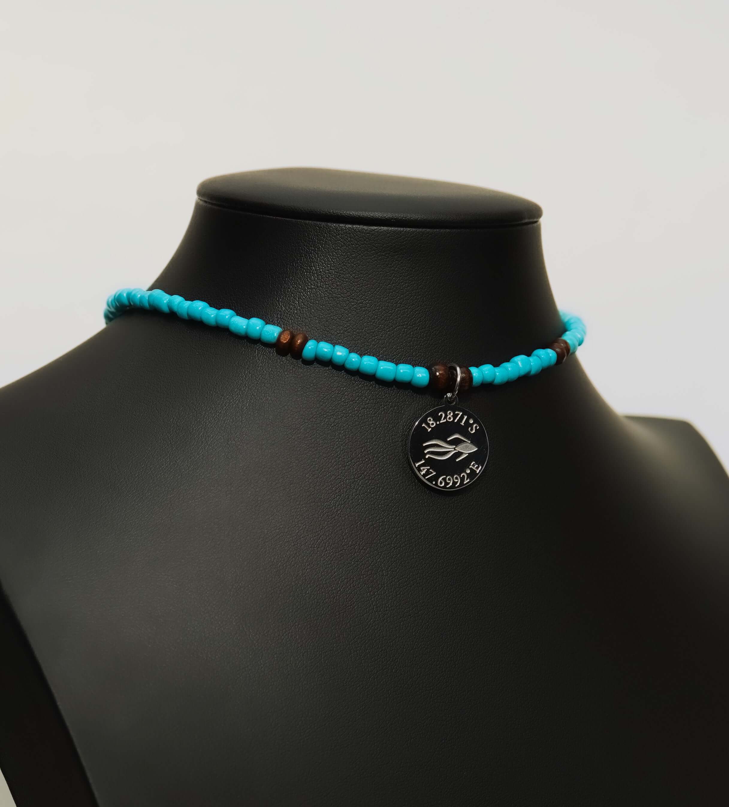 Aquarius Reef's silver 'Reef' choker - a turquoise and silver unisex beaded choker necklace from Aquarius Reef's Classic collection, featuring a pendant with coordinates of the Great Barrier Reef.