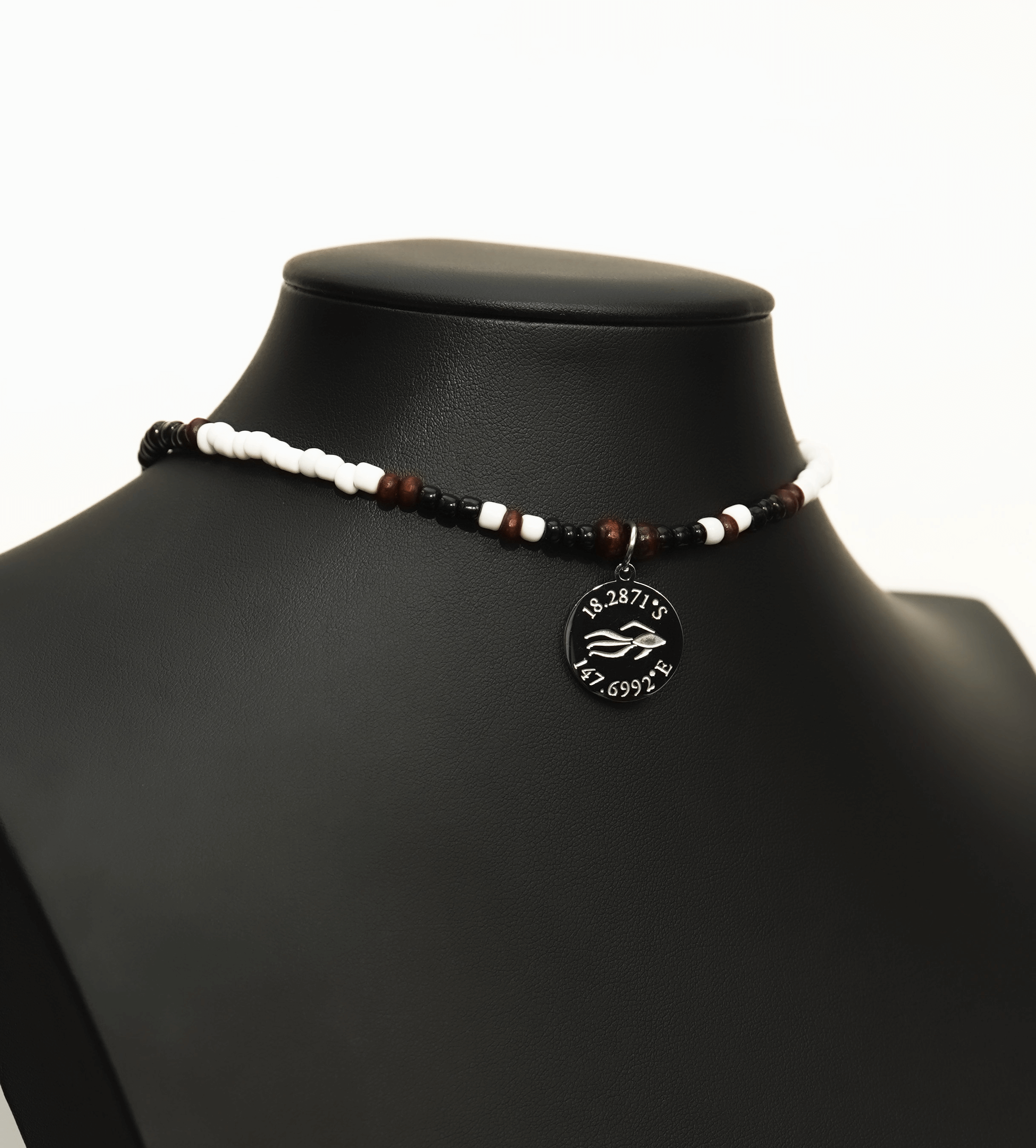 Aquarius Reef's silver 'Sparrow' choker - a black and white patterned unisex seed beaded choker necklace in gold from Aquarius Reef's Edge collection, featuring a pendant with coordinates of the Great Barrier Reef.