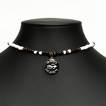 Aquarius Reef's silver 'Sparrow' choker - a black and white patterned unisex seed beaded choker necklace in gold from Aquarius Reef's Edge collection, featuring a pendant with coordinates of the Great Barrier Reef.