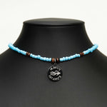 Aquarius Reef's 'West Coast' choker - a powder blue unisex beaded choker necklace in silver from Aquarius Reef's Classic collection, featuring a pendant with coordinates of the Great Barrier Reef.